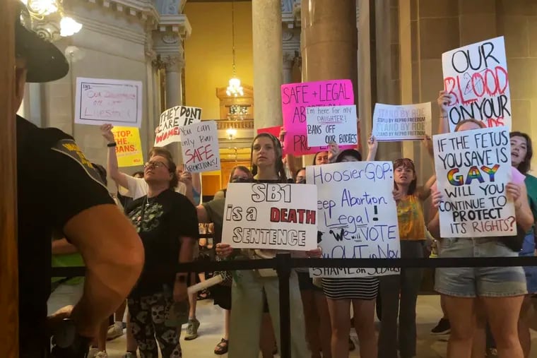 Abortion-rights protesters fill Indiana Statehouse corridors and cheer outside legislative chambers, Friday, Aug. 5, 2022, as lawmakers vote to concur on a near-total abortion ban, in Indianapolis.