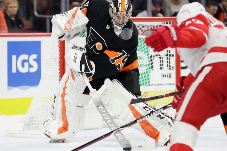 Flyers goaltender Carter Hart, controlling the puck against Detroit in a Feb. 16 game, is making strides from an ankle injury.