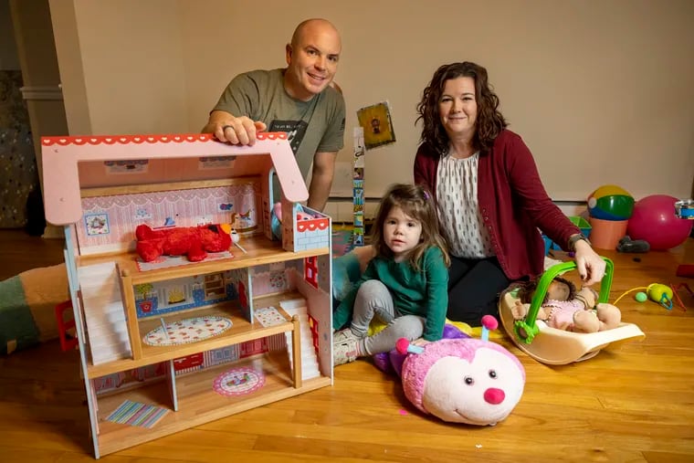 Cosima Fishburn, 2, with parents Monica Sweeney (right) and father Shaun Fishburn in their King of Prussia home on Wednesday morning November 30, 2022.