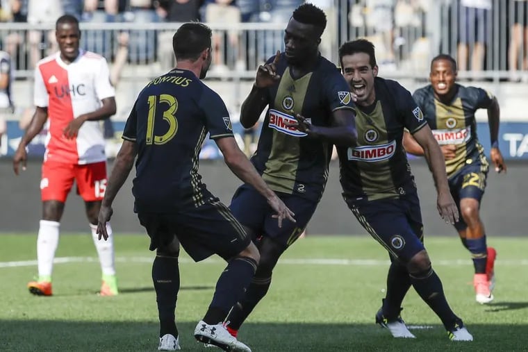 The Union’s  C.J. Sapong (center) celebrates after scoring on a  penalty kick with Chris Pontius (left) and  Ilsinho.