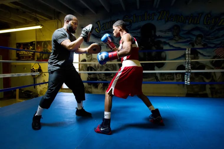 Stephen Fulton Jr. (right) working out in the ring with trainer Hamza Muhammad in April 2013.