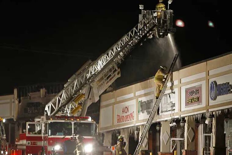 Cheltenham Township and Huntingdon Valley fire departments work to put out a deadly fire in the Melrose Shopping Center along Cheltehman Avenue on Friday morning, Jan. 25, 2013. (Alejandro A. Alvarez / Staff Photographer)