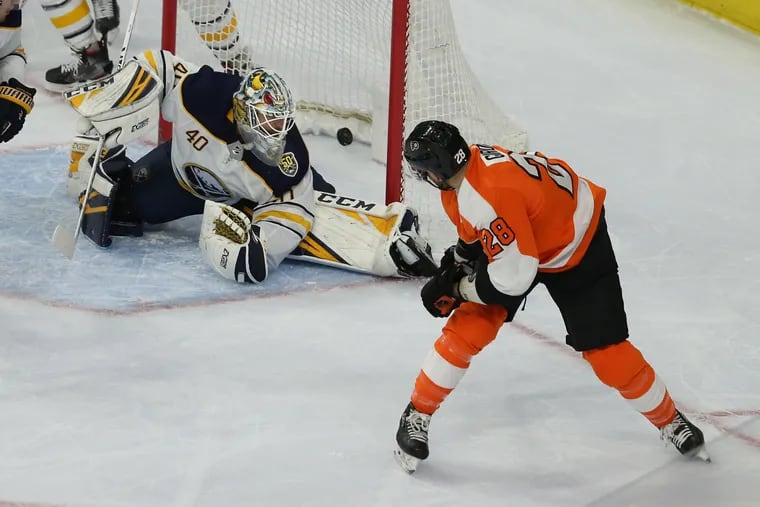 Claude Giroux, right, of the Flyers scores against Carter Hutton of the Sabres during the 2nd period at the Wells Fargo Center on March 7, 2020.