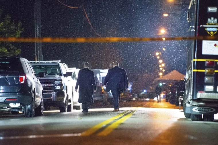 The FBI investigates in the rain after an active shooter situation at the Tree of Life Congregation on Saturday, Oct. 27, 2018, in the Squirrel Hill section of Pittsburgh. A gunman opened fire at the synagogue, killing multiple people and injuring others in one of the deadliest attacks on Jews in U.S. history.