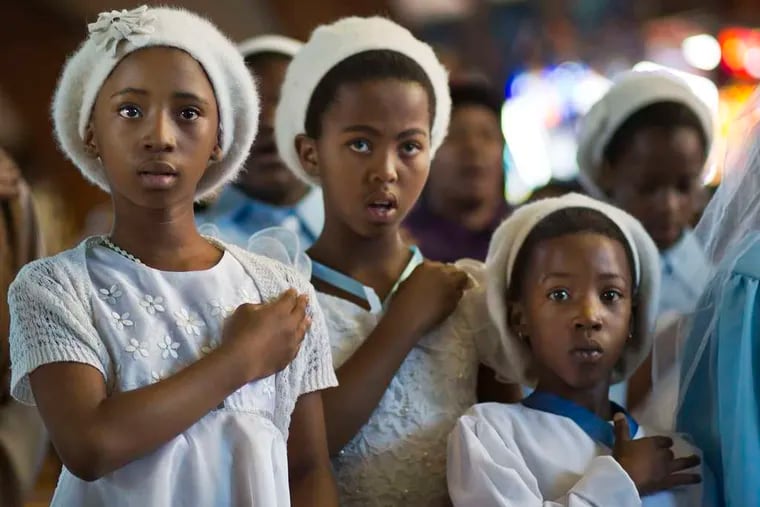 Young choir members attend a Mass for Nelson Mandela at the Regina Mundi church, a focal point of the antiapartheid struggle, in Soweto.