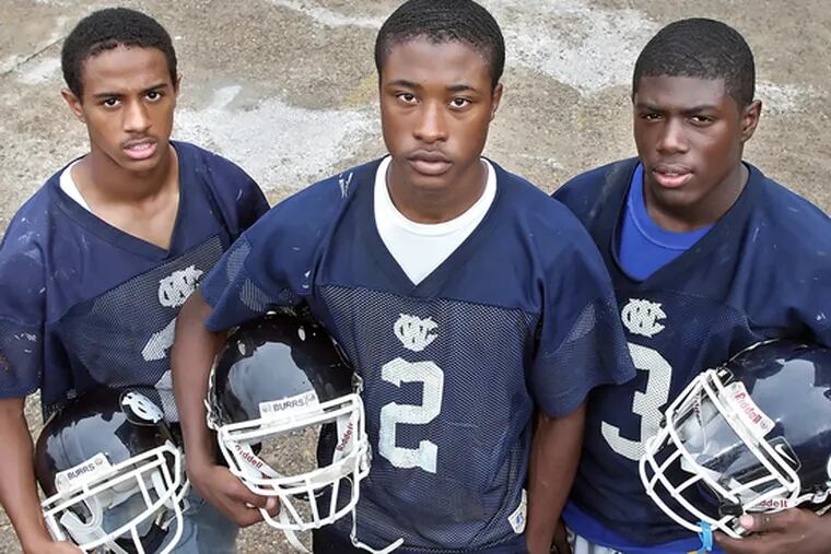 Curtis Drake stands between West Catholic teammates Rob Hollomon (left) and Raymond Maples. The Associated Press all-state team boasts all three, plus four others from the area.