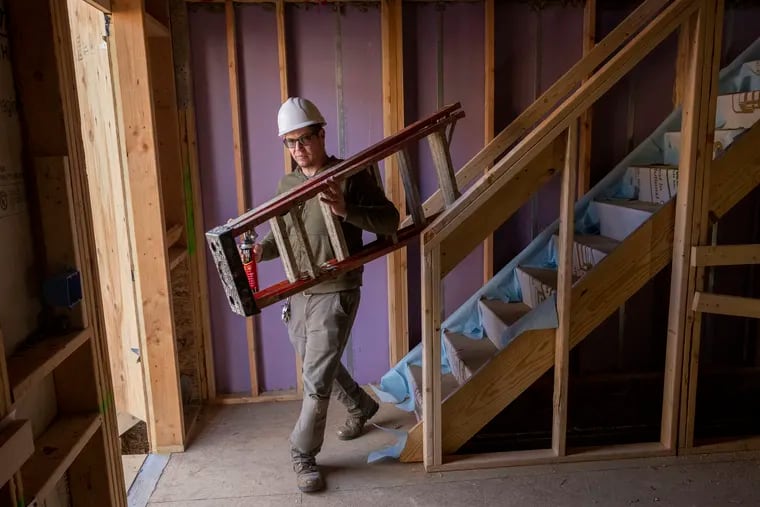 Will Lambrakos, senior lead carpenter with Habitat for Humanity, takes care of filling wire holes before insulation and drywall at a Habitat job site at 1600 Page St. Habitat for Humanity now offers a one-month sabbatical to employees.