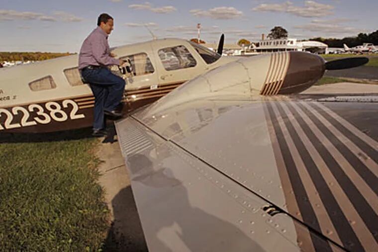 Paul DeSanctis, 39, climbs into the cockpit of his 1978 Piper Seneca that he is selling. (Jonathan Wilson / Staff Photographer)