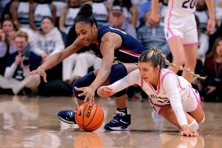 Bella Runyan (right) of Villanova and Aubrey Griffin of UConn dive after a loose ball during the 2nd half on Feb. 18, 2023 at the Finneran Pavilion at Villanova University.