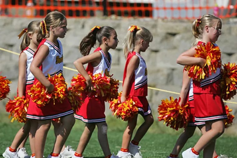 Haverford cheerleaders take to the sidelines during the inaugural games at the site of the former Haverford State Hospital. Two more athletic fields are planned, for a total of four. (David Swanson / Staff Photographer)