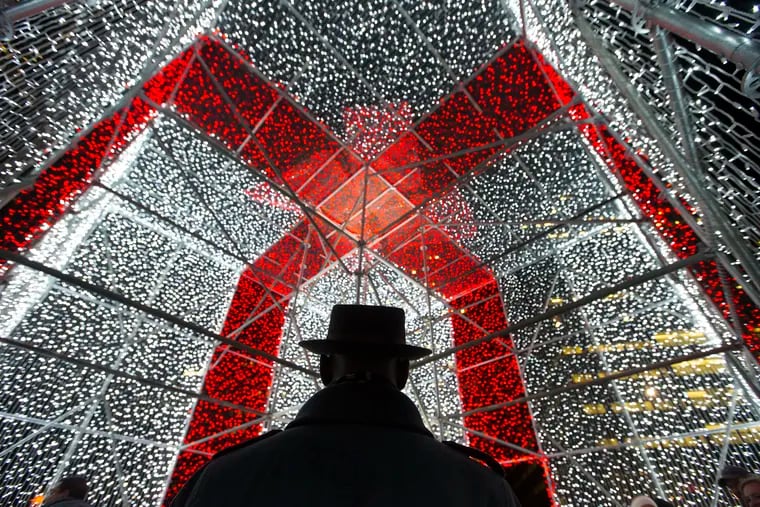 The Present at Love Park is sponsored by Bank of America to raise money for Philadelphia Parks, children’s books, and help for the homeless.  Darryl Glover stands inside the three dimensional gift box made of strings of lights at Love Park on Dec. 7, 2018,