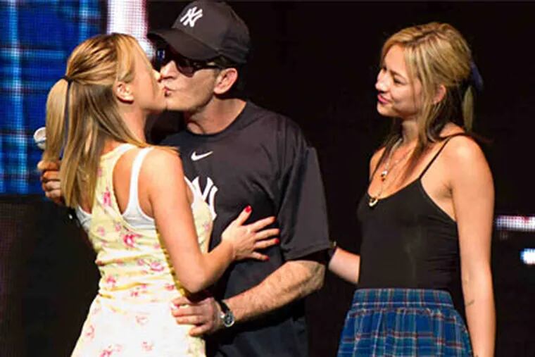 Charlie Sheen with his "goddesses" Rachel Oberlin (left) and Natalie Kenley. (AP Photo)