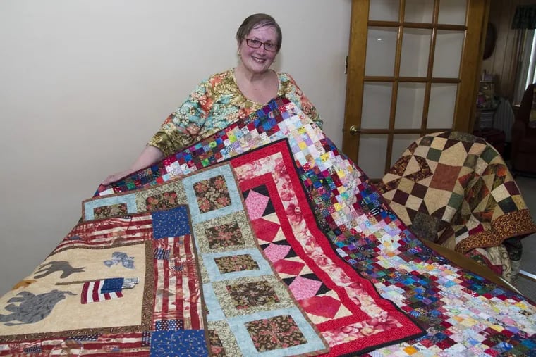 Quilt maker Donna Laing, 67, displays some of her favorites in her Warminster home workshop. She will be among 80 artisans exhibiting 121 quilts at the 13th Annual Bucks County Quilt Show in Bensalem throughout July and August. CLEM MURRAY/ Staff Photographer