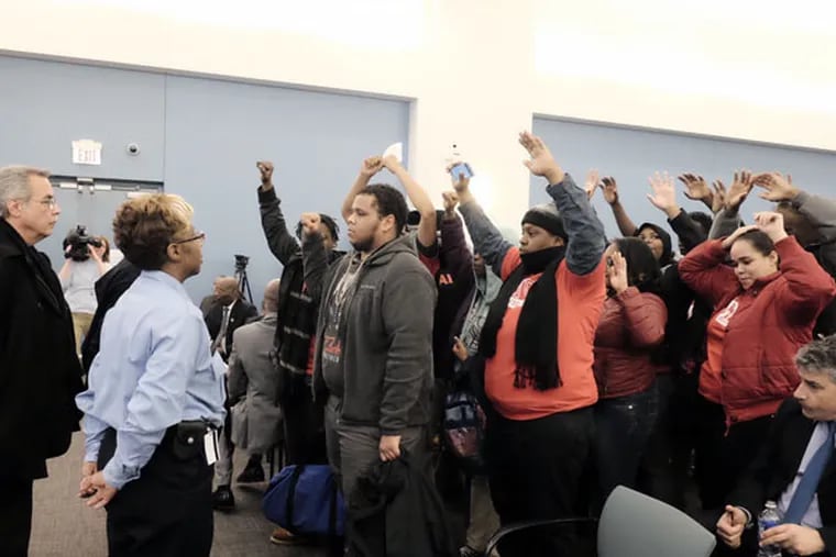 Protesters disrupt the start of the SRC charter school hearing on Tuesday, Feb. 18, 2015. (Ed Hille / Staff Photographer)