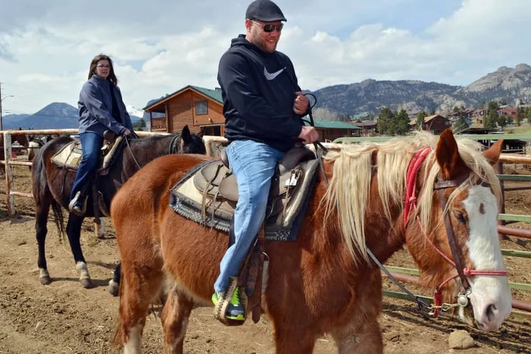 At Sombrero Ranches stables in Estes Park, Colo., Christian Styles rides a Belgian draft horse while Katy Little rides a quarter horse. P. Solomon Banda / AP