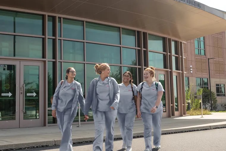 Nursing students walk on St. Joseph's University's new site in Lancaster. The university has completed a merger with the Pennsylvania College of Health Sciences there.