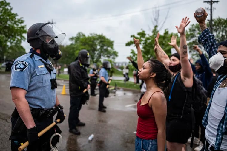 Protesters and police face each other during a rally for George Floyd in Minneapolis on May 26, 2020.