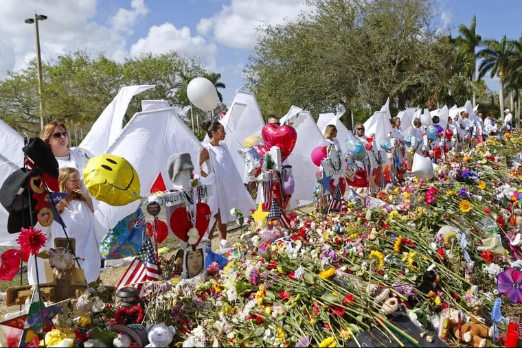 Angels paying tribute at the memorial for the victims of the shooting at Marjory Stoneman Douglas High School on February 25, 2018, during an open house as parents and students returned to the school for the first time since 17 people were killed in a mass shooting at the school in Parkland on February 14.
