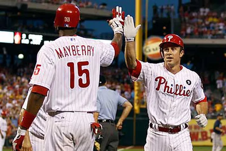 Chase Utley is congratulated by John Mayberry Jr. after scoring in the first inning. (Yong Kim/Staff Photographer)