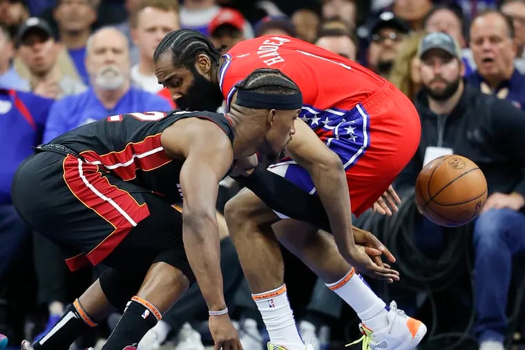 Sixers guard James Harden and Miami Heat forward Jimmy Butler go after a loose ball during the third quarter Sunday.