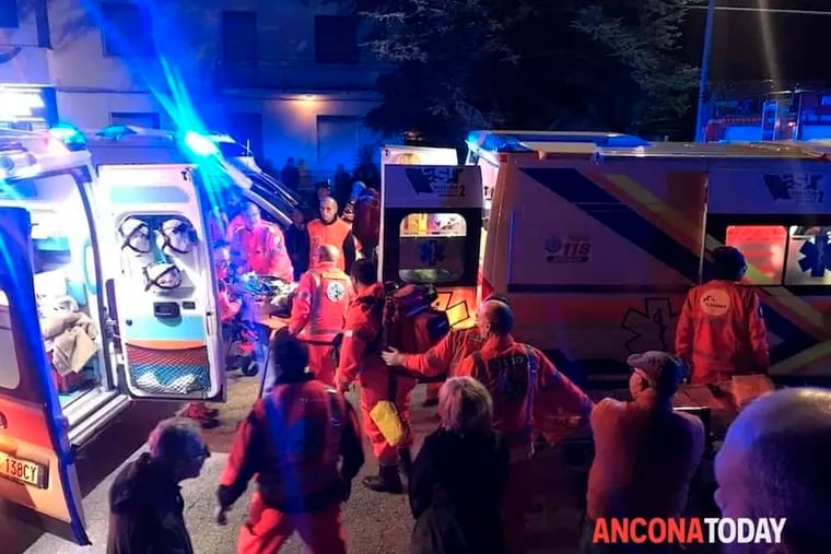 Rescuers assist injured people outside a nightclub in Corinaldo, central Italy, early Saturday, Dec. 8, 2018. At least six people, all but one of them minors, were killed and about 35 others injured in a stampede of panicked concertgoers early Saturday at a disco in a small town on Italy's central Adriatic coast. (Stefano Pagliarini/Ancona Today via AP)