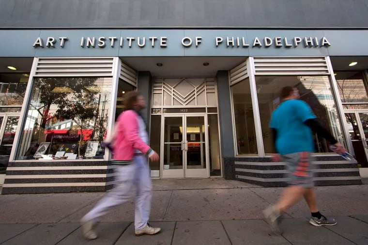 People walk past the Art Institute of Philadelphia operated by the Education Management Corporation on Nov. 16, 2015, in Philadelphia. The Biden administration on Wednesday said it will cancel $6 billion in student loans for people who attended the Art Institutes, a system of for-profit colleges that closed the last of its campuses in 2023 amid accusations of fraud. (AP Photo/Matt Rourke, File)