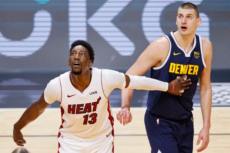 Bam Adebayo of the Miami Heat and Nikola Jokic of the Denver Nuggets look on during the first quarter at American Airlines Arena on January 27, 2021 in Miami, Florida. (Photo by Michael Reaves/Getty Images)