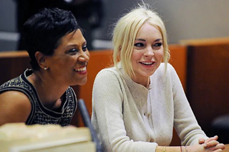 Attorney Shawn Holley and Lindsay Lohan are all smiles at the actress' progress report session at Los Angeles Superior Court. (Michael Nelson / Associated Press)