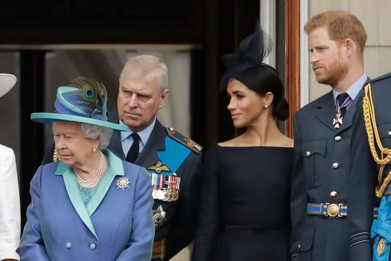 FILE - In this Tuesday, July 10, 2018 file photo Britain's Queen Elizabeth II, Prince Andrew, Meghan the Duchess of Sussex and Prince Harry stand on a balcony to watch a flypast of Royal Air Force aircraft pass over Buckingham Palace in London. As part of a surprise announcement distancing themselves from the British royal family, Prince Harry and his wife Meghan declared they will "work to become financially independent" — a move that has not been clearly spelled out and could be fraught with obstacles.