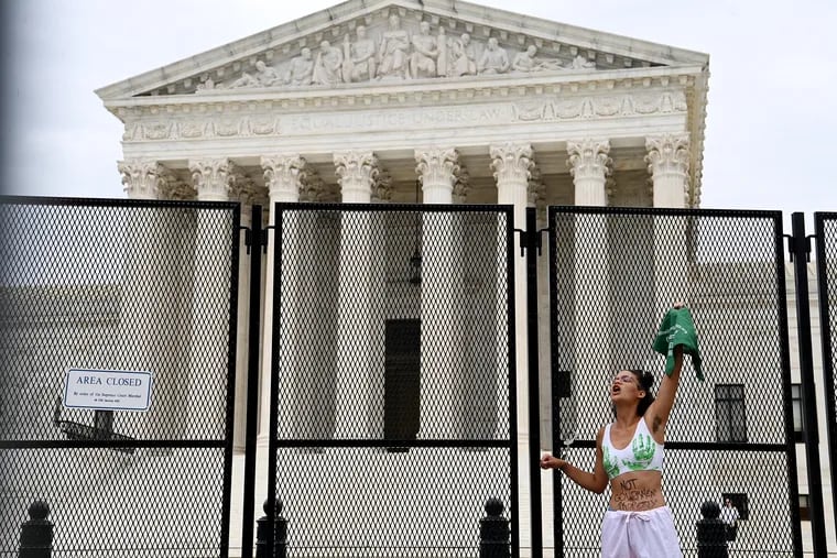 An abortion rights activist handcuffs herself to a fence surrounding the U.S. Supreme Court Building last month.