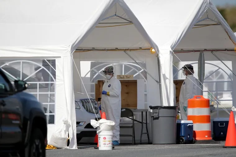 A vehicle pulls into a drive-in coronavirus testing site at Rowan College of South Jersey in Sewell, N.J. Wednesday.