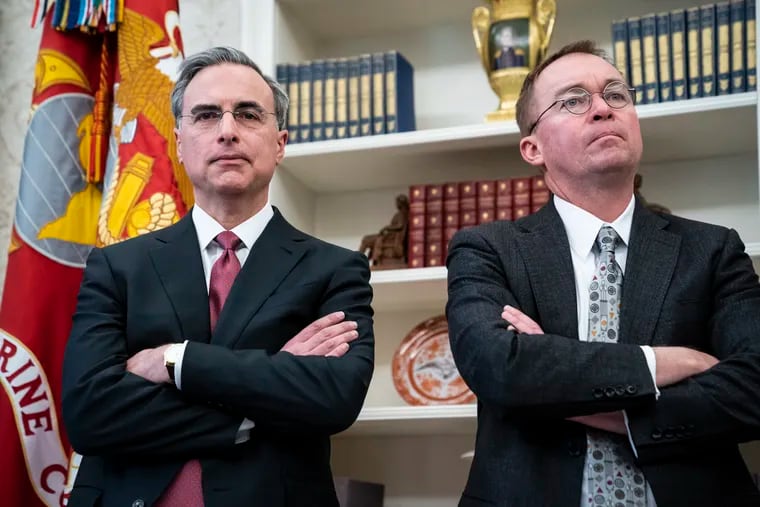 White House counsel Pat Cipollone, left, and Director of the Office of Management and Budget Mick Mulvaney, listen to an Oval Office meeting in December. Cipollone is building a legal team to promote President Donald Trump's executive privilege amid several investigations into his campaign and businesses.