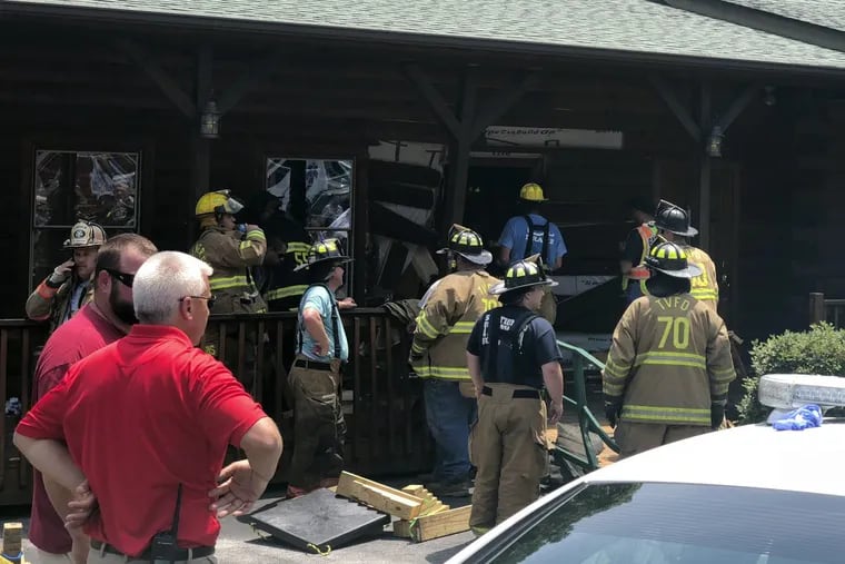 Authorities work the scene of a restaurant where police say a man intentionally rammed a vehicle into the building, killing members of his own family.