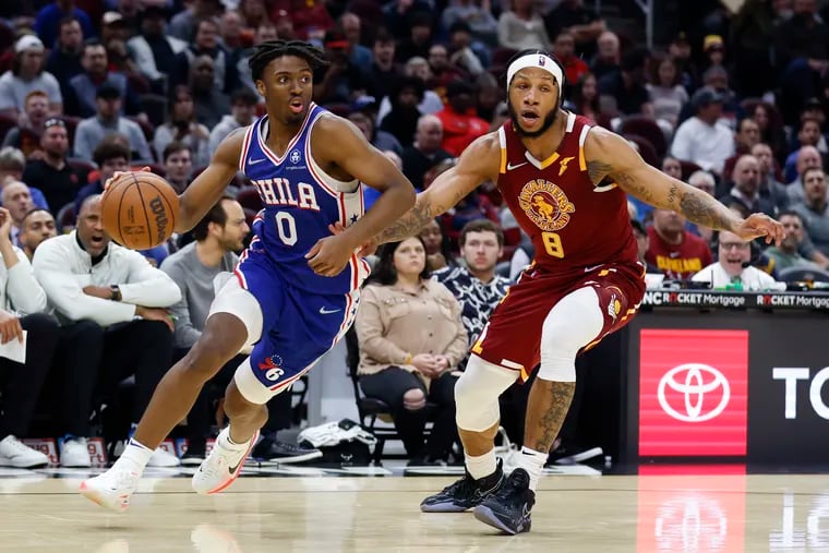 Philadelphia 76ers' Tyrese Maxey (0) drives against Cleveland Cavaliers' Lamar Stevens (8) during the second half of an NBA basketball game Wednesday, March 16, 2022, in Cleveland. (AP Photo/Ron Schwane)