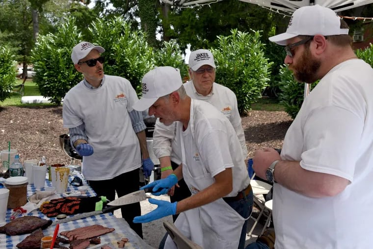 Preparing their brisket entry, Jeff Klein (center, with knife) of Jake’s Kosher Smoked Meat on Haverford Avenue works with his “minions” (left to right) Jonathan Zaslow, Sanford Bruck, and Adam Levine at Temple Beth Hillel-Beth El’s Hava NaGrilla, the first kosher BBQ championship in the Mid-Atlantic region.