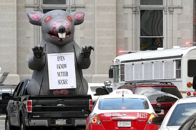 The rat, this one owned by the Teamsters, disrupts traffic around City Hall during the Nutter era. The NLRB will hear a case challenging Local 98's use of the rat last summer outside a Center City hotel and restaurant.
