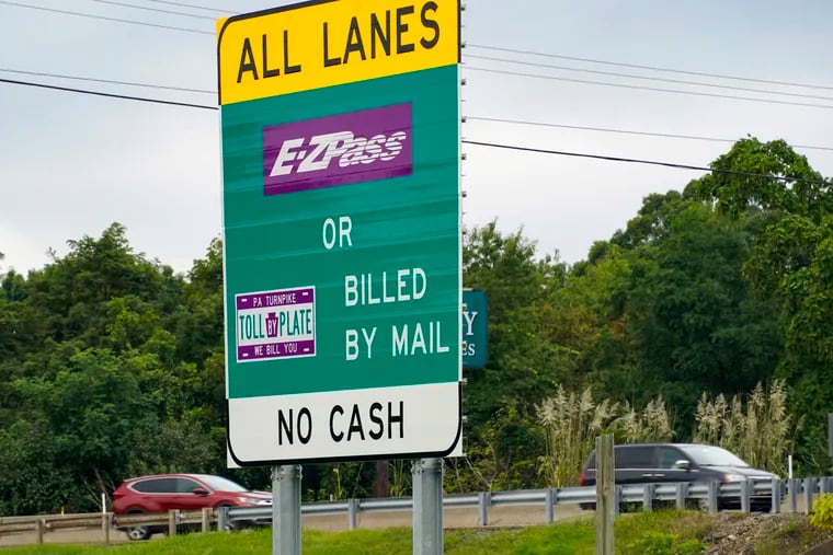 Signs on the entrance ramp in Gibsonia, Pa., indicate to motorists the methods being used to collect tolls on the Pennsylvania Turnpike.