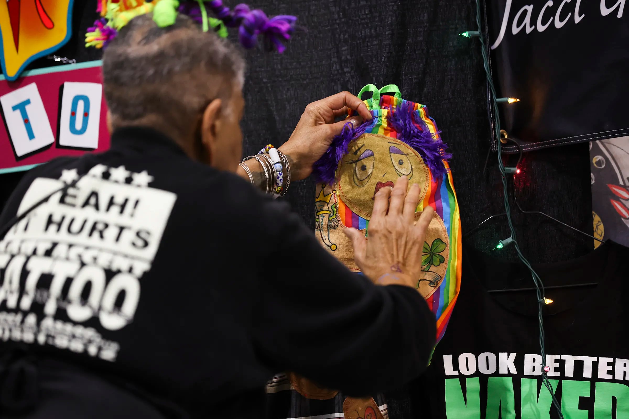 Tattoo artist Jacci Gresham hangs up her work at the Philadelphia Tattoo Arts Festival at the Convention Center in Philadelphia on Jan. 27.