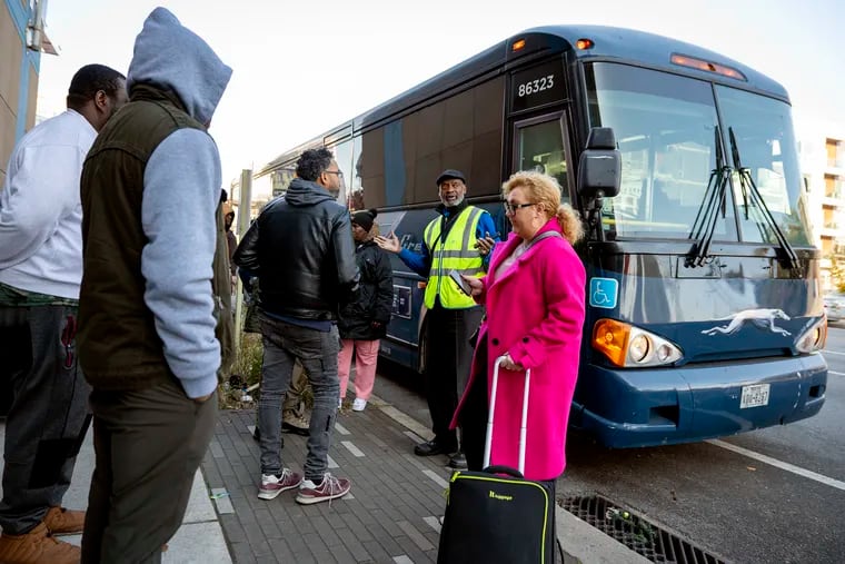A Greyhound driver assisted riders waiting for buses at the “temporary terminal" for intercity buses at Spring Garden Street and Delaware Avenue in November. City officials recently floated a proposal to make the first level of the AutoPark garage on South Second Street near Walnut Street into a terminal for intercity bus carriers.