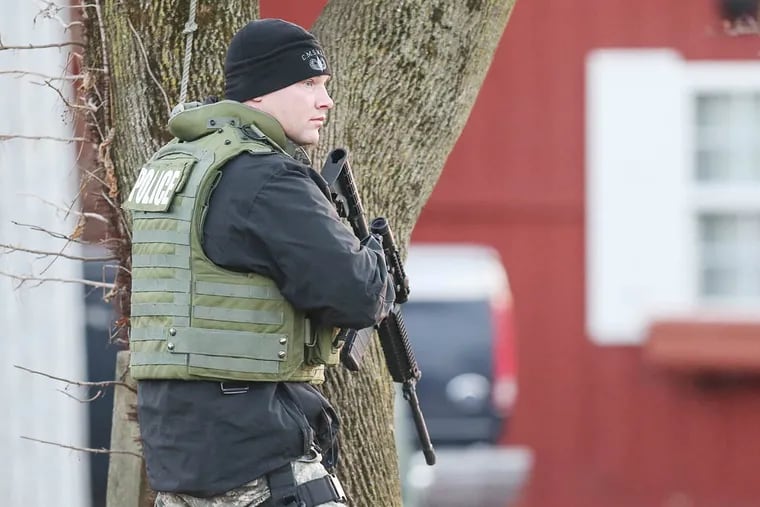 County SWAT units surround the home of Bradley William Stone, 35, of Pennsburg, Pa., a suspect in six shooting deaths in Montgomery County  Monday, December 15, 2014.   (  Steven M. Falk / Staff Photographer )