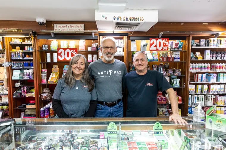 Longtime Artifax employees Mindy Flood (left) and Larry Dresnin (right) with owner Brent Brookstein (center) at the store in Northeast Philadelphia that Brookstein opened in 1976.