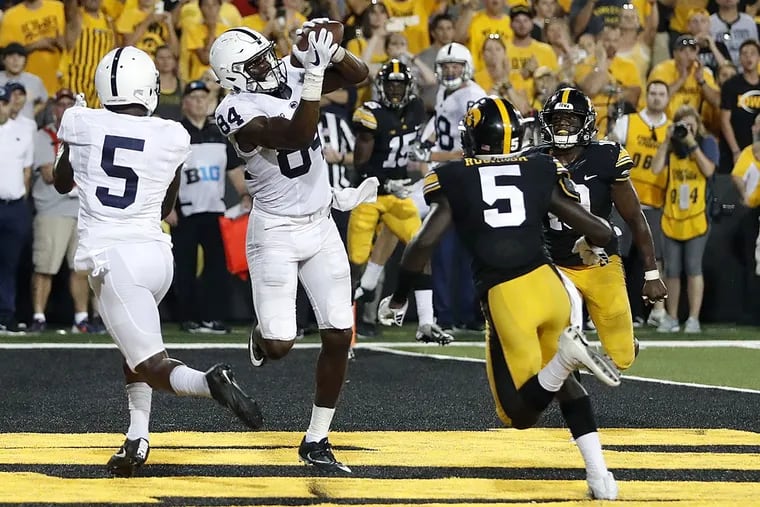 Penn State wide receiver Juwan Johnson (84) catches a touchdown pass between teammate DaeSean Hamilton, left, and Iowa defensive backs Manny Rugamba and Miles Taylor, right, as time expires in an NCAA college football game Saturday, Sept. 23, 2017, in Iowa City, Iowa.