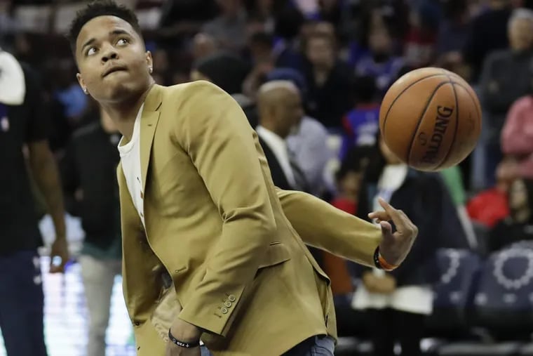injured Sixers guard Markelle Fultz tosses the basketball during the half-time warmups against the New Orleans Pelicans on Friday, February 9, 2018 in Philadelphia.