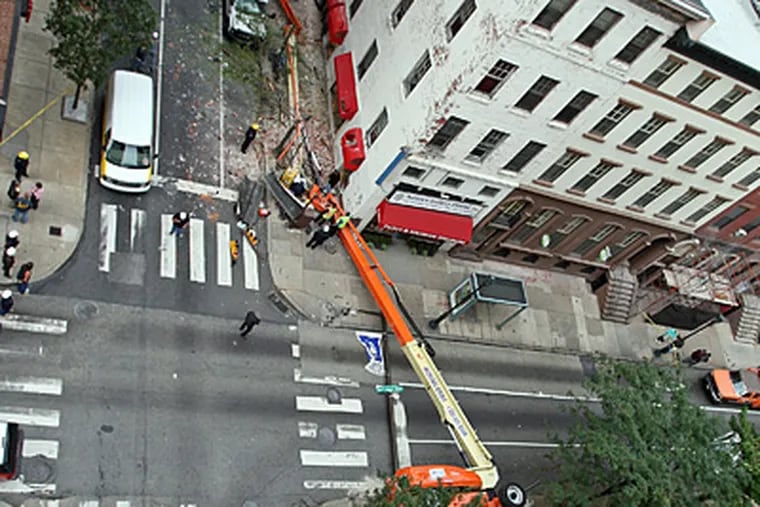 Overlooking the scene of a fatal lift accident at 21st and Walnut streets in Center City. (Steven M. Falk / Staff)