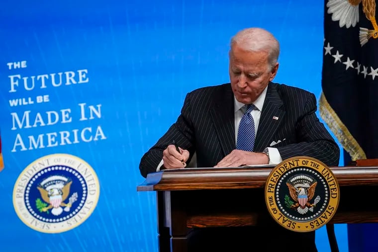 U.S. President Joe Biden signs an executive order aimed at boosting American manufacturing and strengthening the federal government's Buy American rules in January.