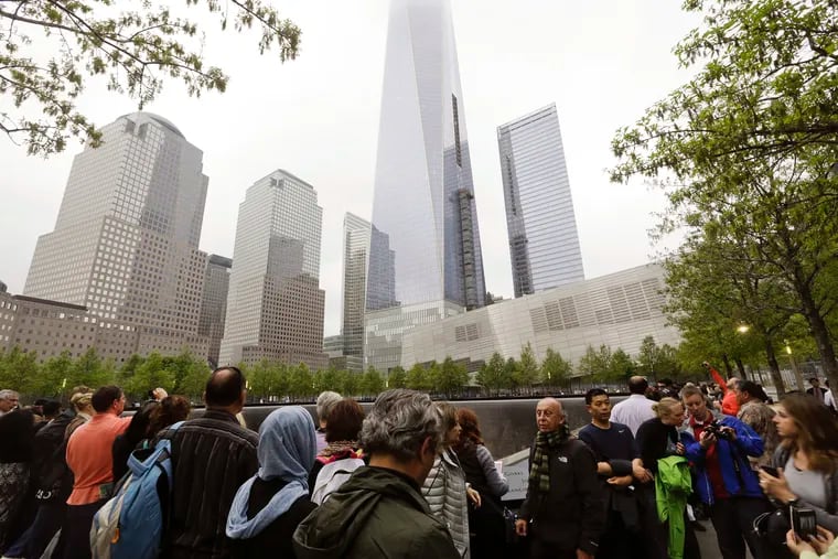In this May 15, 2015 file photo, visitors gather near the pools at the 9/11 Memorial in New York. As they have done 17 times before, victims' relatives are expected at the site on Wednesday, Sept. 11, 2019 to observe the anniversary of the deadliest terror attack on American soil.