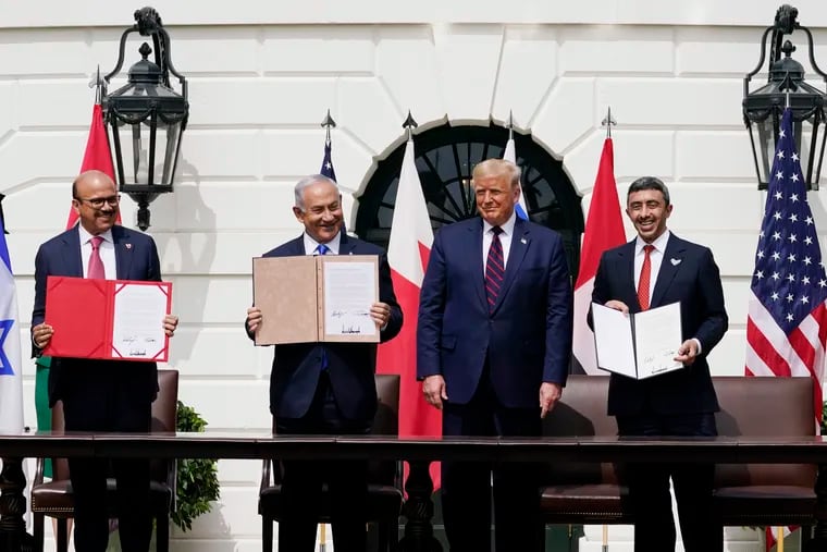 President Donald Trump, center, with from left, Bahrain Foreign Minister Khalid bin Ahmed Al Khalifa, Israeli Prime Minister Benjamin Netanyahu, Trump, and United Arab Emirates Foreign Minister Abdullah bin Zayed al-Nahyan, during the Abraham Accords signing ceremony on the South Lawn of the White House.