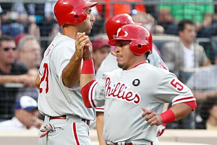 Raul Ibanez and Carlos Ruiz celebrate after scoring on John Mayberry's hit in the second. (Frank Franklin/AP)