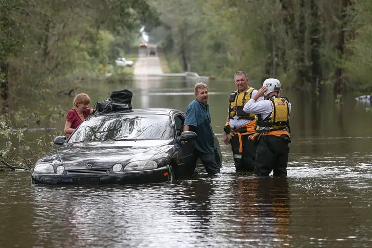 Pennsylvania Task Force One Urban Search & Rescue's John Getty and Mike Fanning help Ray and Shirley after getting stuck on Red Road on the Hayes Swamp in Little Rock S.C.