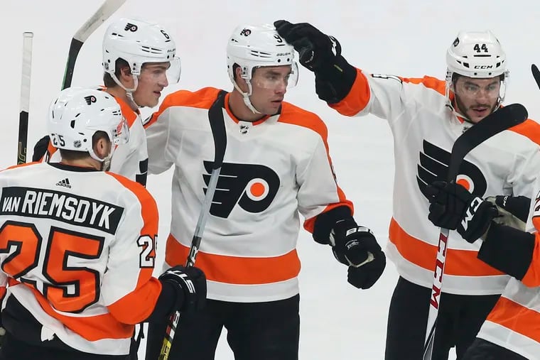 The Flyers' Ivan Provorov is congratulated after a goal. The team will be wearing advertisements on their helmets this season, starting with Wednesday's opener against visiting Pittsburgh.